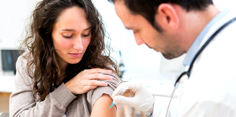 Frau bekommt vom Arzt eine Impfung